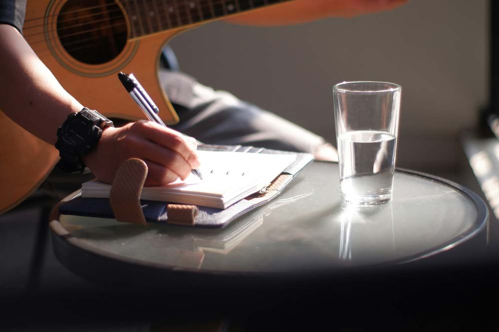 Guitarist with pen and paper