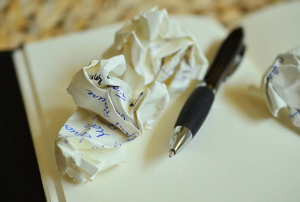 crumpled up paper plus a pen