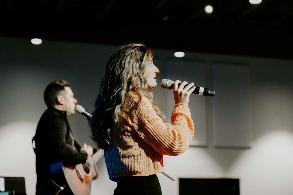 A band, man and woman singing